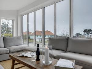 a living room with a couch and a table at Holiday Home Ebke - 70m from the sea in Sealand by Interhome in Gilleleje