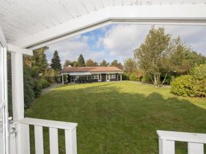 a view of a house from the porch of a house at Holiday Home Cedomir - 625m from the sea in Sealand by Interhome in Hornbæk