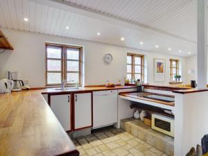 eine Küche mit weißen Wänden und hölzernen Arbeitsplatten in der Unterkunft Holiday Home Ilena - 16-3km from the sea in Sealand by Interhome in Borup