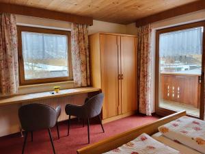 a hotel room with two beds and a window at Apartment Apart Maashof III by Interhome in Galtür