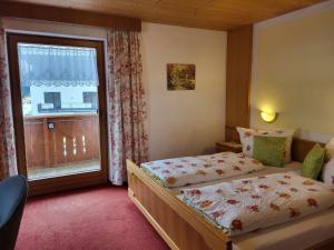 a bedroom with two beds and a window at Apartment Apart Maashof III by Interhome in Galtür