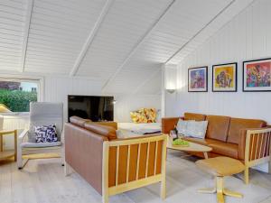 a living room with a couch and a table at Holiday Home Eivor - 500m from the sea in Sealand by Interhome in Hornbæk