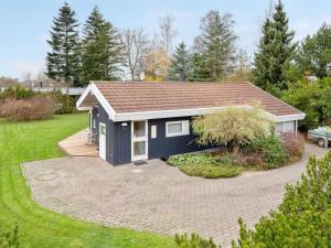 a small house with a gambrel roof at Holiday Home Rixa - 525m from the sea in Sealand by Interhome in Slagelse