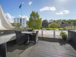 a patio with a table and chairs on a roof at Apartment Liv - 50m from the sea in Sealand by Interhome in Helsingør