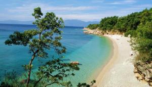 a view of a beach with people in the water at Apartment Blue&Green in Kostrena