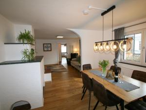 a dining room and living room with a table and chairs at Apartment Lisa by Interhome in Wiesing