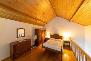 a bedroom with a bed and a wooden ceiling at Casa de Valdemar in Felgueiras +81 photos