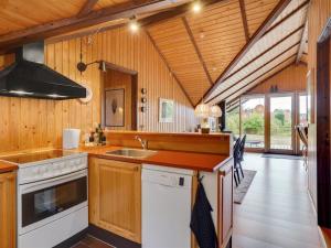 a kitchen with a sink and a stove at Holiday Home Ija - 200m from the sea in Sealand by Interhome in Føllenslev