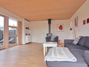 a living room with a couch and a table at Holiday Home Jasper - 175m to the inlet in Sealand by Interhome in Karrebæksminde
