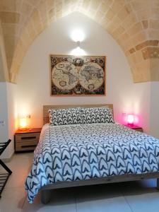 a bedroom with a large bed with a painting on the wall at Appartamento B&B VOLTE D'OGIVA in Altamura