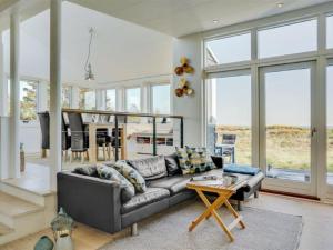 uma sala de estar com um sofá e uma mesa em Holiday Home Helin - 100m from the sea in Sealand by Interhome em Yderby