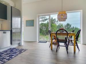 ein Esszimmer mit einem Tisch und Stühlen in einer Küche in der Unterkunft Holiday Home Gjorgje - 100m from the sea in Sealand by Interhome in Tjørneholm