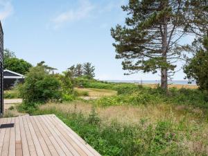 eine Holzterrasse mit Meerblick in der Unterkunft Holiday Home Gjorgje - 100m from the sea in Sealand by Interhome in Tjørneholm