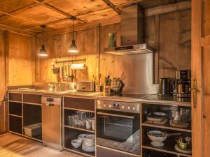 a large kitchen with a stove and a sink at Apartment Josefa am Buchhammerhof by Interhome in Kaunerberg