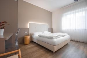 Letto o letti in una camera di Hotel Rolly