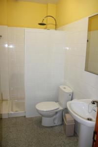 a bathroom with a toilet and a sink at Pozo Izquierdo Homelidays in Pozo Izquierdo
