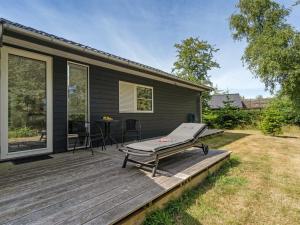 a wooden deck with a picnic table on a house at Holiday Home Jelke - 50m from the sea by Interhome in Gedser