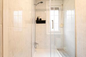a shower with a glass door in a bathroom at Lodging Apartments Barceloneta Mar in Barcelona