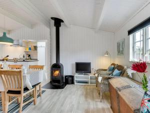- un salon doté d'un poêle à bois dans l'établissement Holiday Home Hardina - 300m from the sea in Funen by Interhome, à Martofte