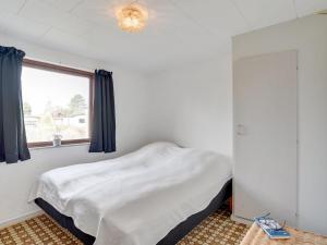 a bedroom with a bed and a window at Holiday Home Henrich - 300m from the sea in Lolland- Falster and Mon by Interhome in Vesterby