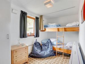 a room with two bunk beds and a desk at Holiday Home Henrich - 300m from the sea in Lolland- Falster and Mon by Interhome in Vesterby