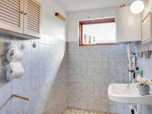 a small bathroom with a sink and a toilet at Holiday Home Henrich - 300m from the sea in Lolland- Falster and Mon by Interhome in Vesterby