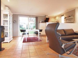 a living room with a couch and a table at Holiday Home Laila - 5m from the sea in Funen by Interhome in Middelfart