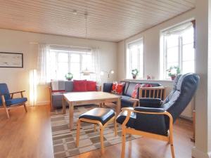 uma sala de estar com um sofá e uma mesa em Holiday Home Store - 700m from the sea in Funen by Interhome em Ebberup