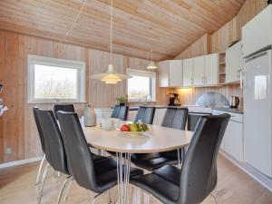 a kitchen and dining room with a table and chairs at Holiday Home Dunya - 400m from the sea in Funen by Interhome in Assens