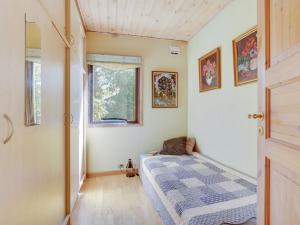 a small bedroom with a bed and a window at Holiday Home Maelle - 600m from the sea by Interhome in Dannemare