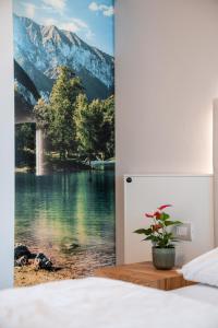 a bedroom with a view of a lake and mountains at Hotel Rolly in Riva del Garda