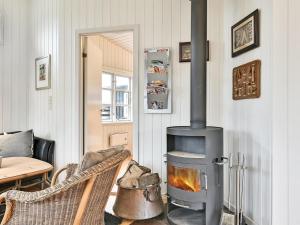 uma sala de estar com um fogão a lenha em Holiday Home Viljami - 20m from the sea in Funen by Interhome em Nyborg