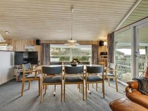 a dining room with a table and chairs at Holiday Home Hjalmar - 400m from the sea by Interhome in Millinge +29 photos