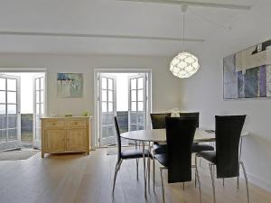 a dining room with a table and chairs at Apartment Terina - 5m from the sea in Funen by Interhome in Bagenkop