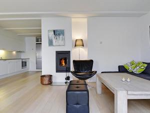 a living room with a couch and a table at Apartment Terina - 5m from the sea in Funen by Interhome in Bagenkop