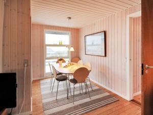 a dining room with a table and chairs at Holiday Home Arton - 300m from the sea in Funen by Interhome in Ebberup