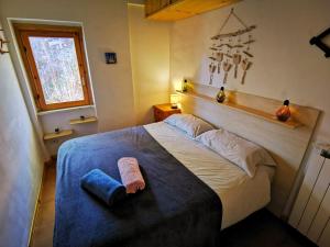 a bedroom with a large bed with a towel on it at Casa Aiello in Camigliatello Silano