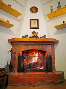 a brick fireplace with a fire in it at Casa Aiello in Camigliatello Silano