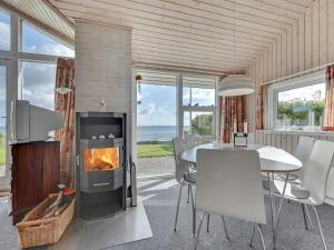 尼堡的住宿－Holiday Home Keti - 5m from the sea in Funen by Interhome，客厅设有壁炉和桌椅