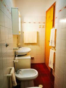 a bathroom with a white toilet and a sink at Casa Aiello in Camigliatello Silano
