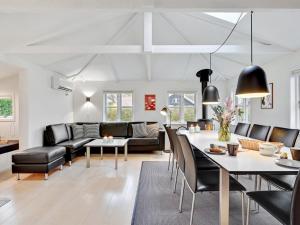 a living room with a couch and a table at Holiday Home Kamilla - 200m from the sea in Funen by Interhome in Nyborg
