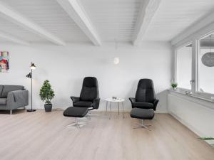 a living room with three chairs and a table at Apartment Constance - 50m from the sea in Funen by Interhome in Svendborg
