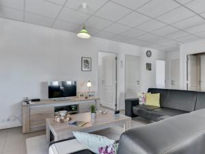 a living room with a couch and a table at Apartment Haralde - 2-5km from the sea by Interhome in Humble