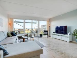 een woonkamer met een bank en een tv bij Apartment Lucjan - 50m from the sea in Funen by Interhome in Assens