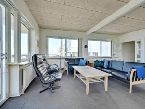 een woonkamer met een bank en een tafel bij Apartment Irma - 25m from the sea in Funen by Interhome in Tranekær