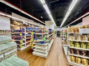 a grocery store aisle with a lot of products at Kuching Kozi Square Apartment in Kuching