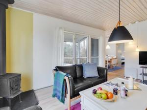 een woonkamer met een zwarte leren bank en een tafel bij Holiday Home Felisa - 300m from the sea by Interhome in Humble