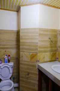 a bathroom with a toilet and a sink at Khalisee Homes Studio apartment in Voi