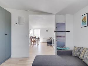 a living room with a couch and a dining room at Apartment Axlan - 50m from the sea in Funen by Interhome in Tranekær