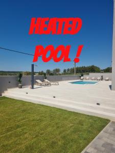 a red sign that reads heard rook next to a pool at Villa Madison in Posedarje